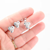 Juego de aretes y anillo con triplete de diamantes en oro blanco de 14 k